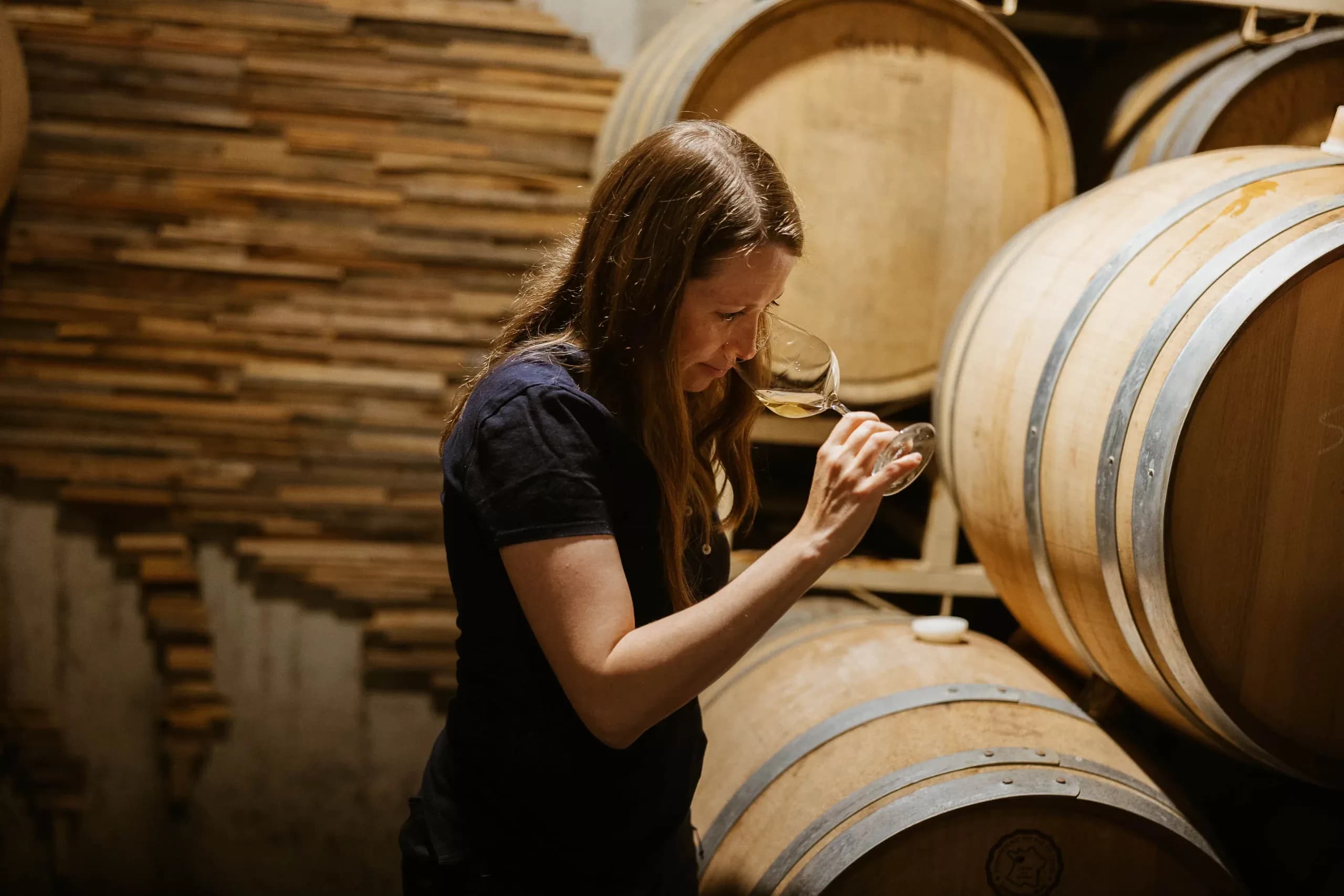 Céline tasting from the barrel in the cellar