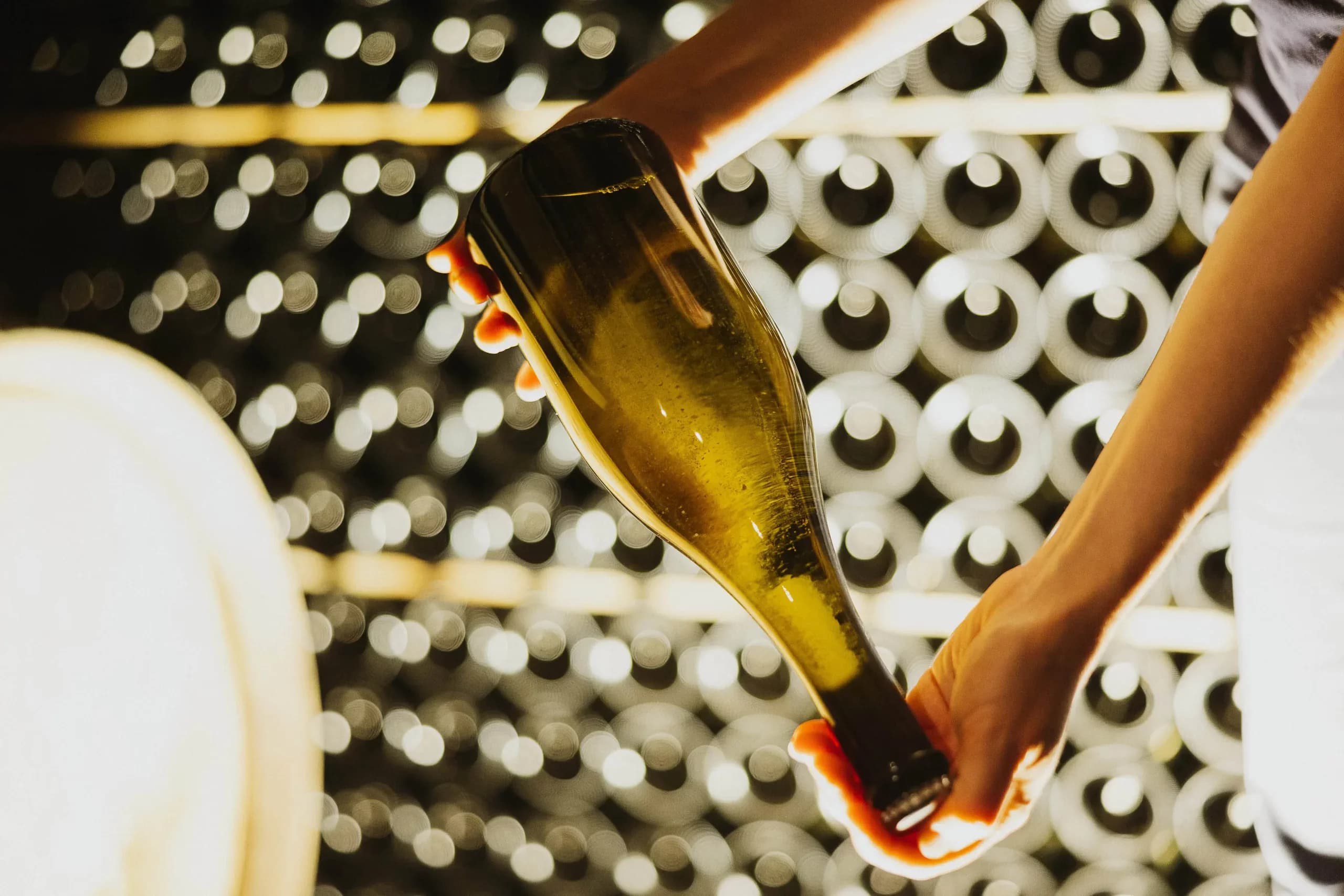 A hand sealing a bottle of sparkling wine at Domaine LeSeurre
