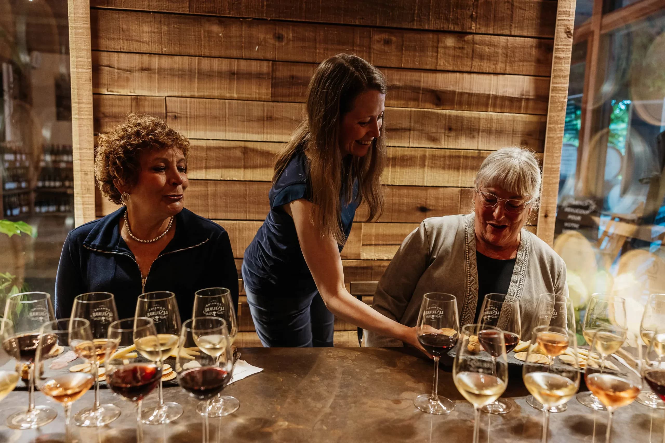 Guests raising a toast with LeSeurre glasses in the tasting room